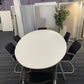 Oval white conference room table and 6 black chairs