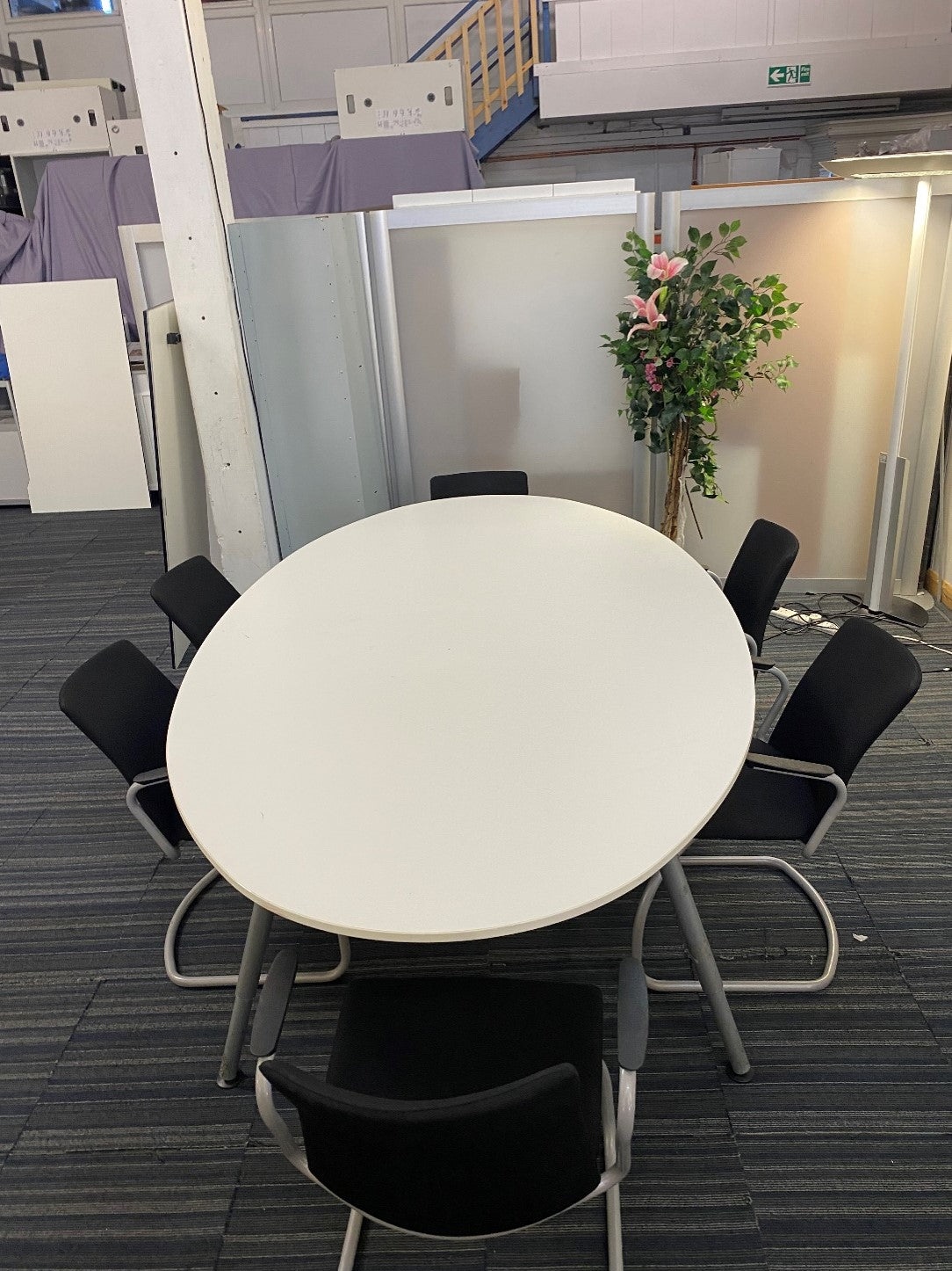 Oval white conference room table and 6 black chairs