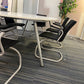 Black cantilever chairs round a white Oval white conference room table