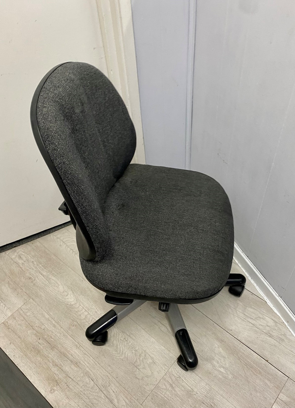 Side of grey home office chair on castors