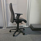 Black swivel desk chair in front of divider