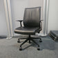 Leather swivel office chair in front of divider