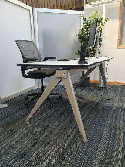 White home office desk setup with swivel chair on wheels