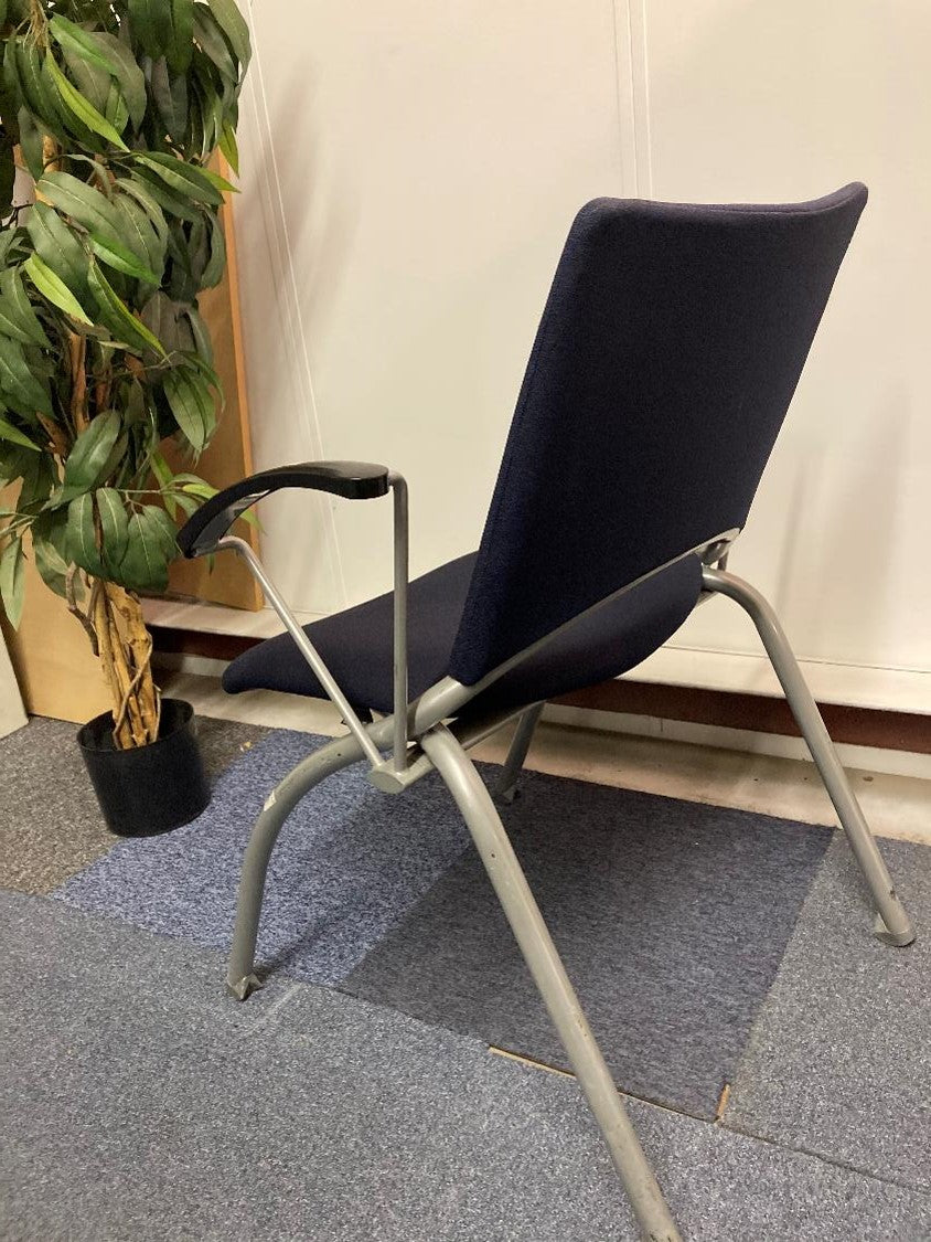 Back of blue chair with armrests and grey stick legs