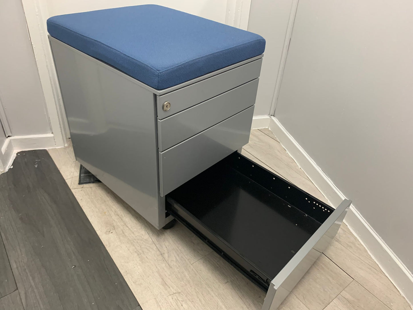 Open bottom drawer of four drawer mobile small cabinet