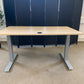 Light brown electric stand up office desk, sit stand height adjustable table in maple finish