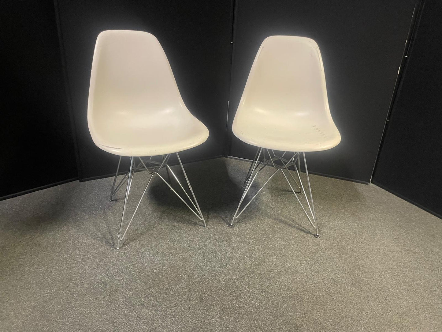 Used Eames Plastic Side Chair DSR by Vitra features a white polypropylene shell and a distinctive chrome "Eiffel" wire base