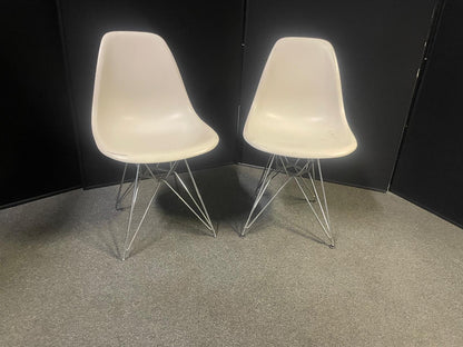 Used Eames Plastic Side Chair DSR by Vitra features a white polypropylene shell and a distinctive chrome "Eiffel" wire base
