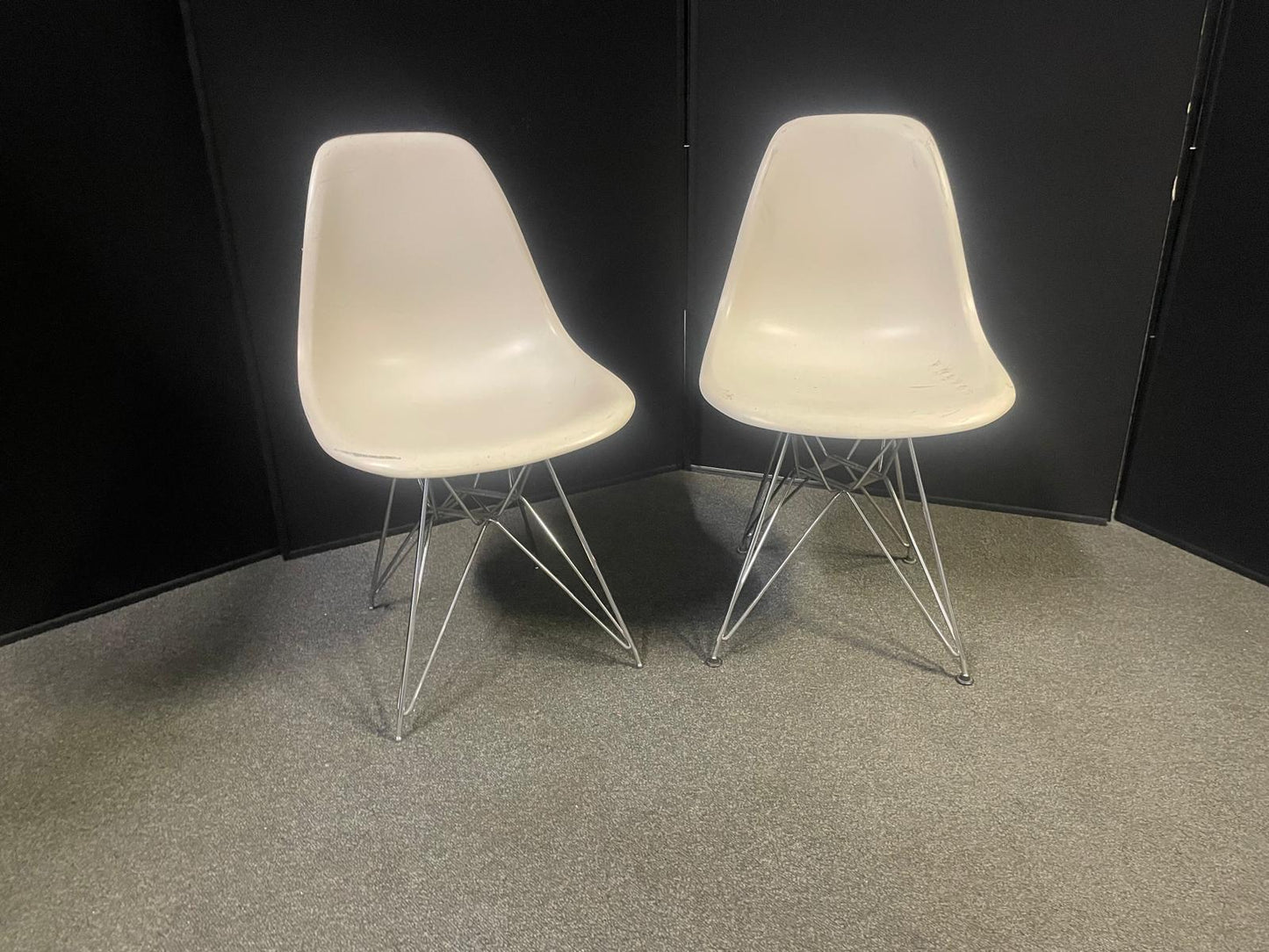 Used Eames Plastic Side Chair DSR by Vitra features a white polypropylene shell and a distinctive chrome "Eiffel" wire base