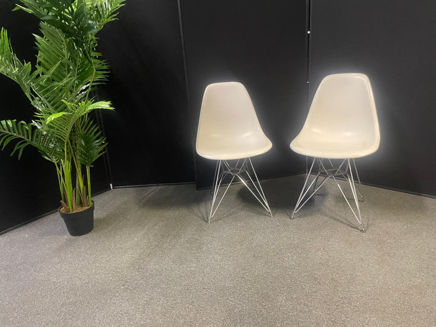 Used Eames Plastic Side Chair DSR by Vitra features a white polypropylene shell and a distinctive chrome "Eiffel" wire base