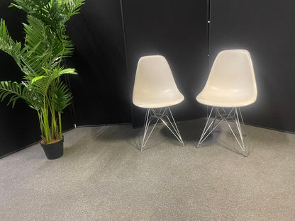 Used Eames Plastic Side Chair DSR by Vitra features a white polypropylene shell and a distinctive chrome "Eiffel" wire base