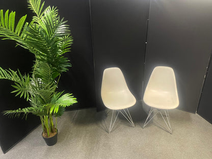 Used Eames Plastic Side Chair DSR by Vitra features a white polypropylene shell and a distinctive chrome "Eiffel" wire base