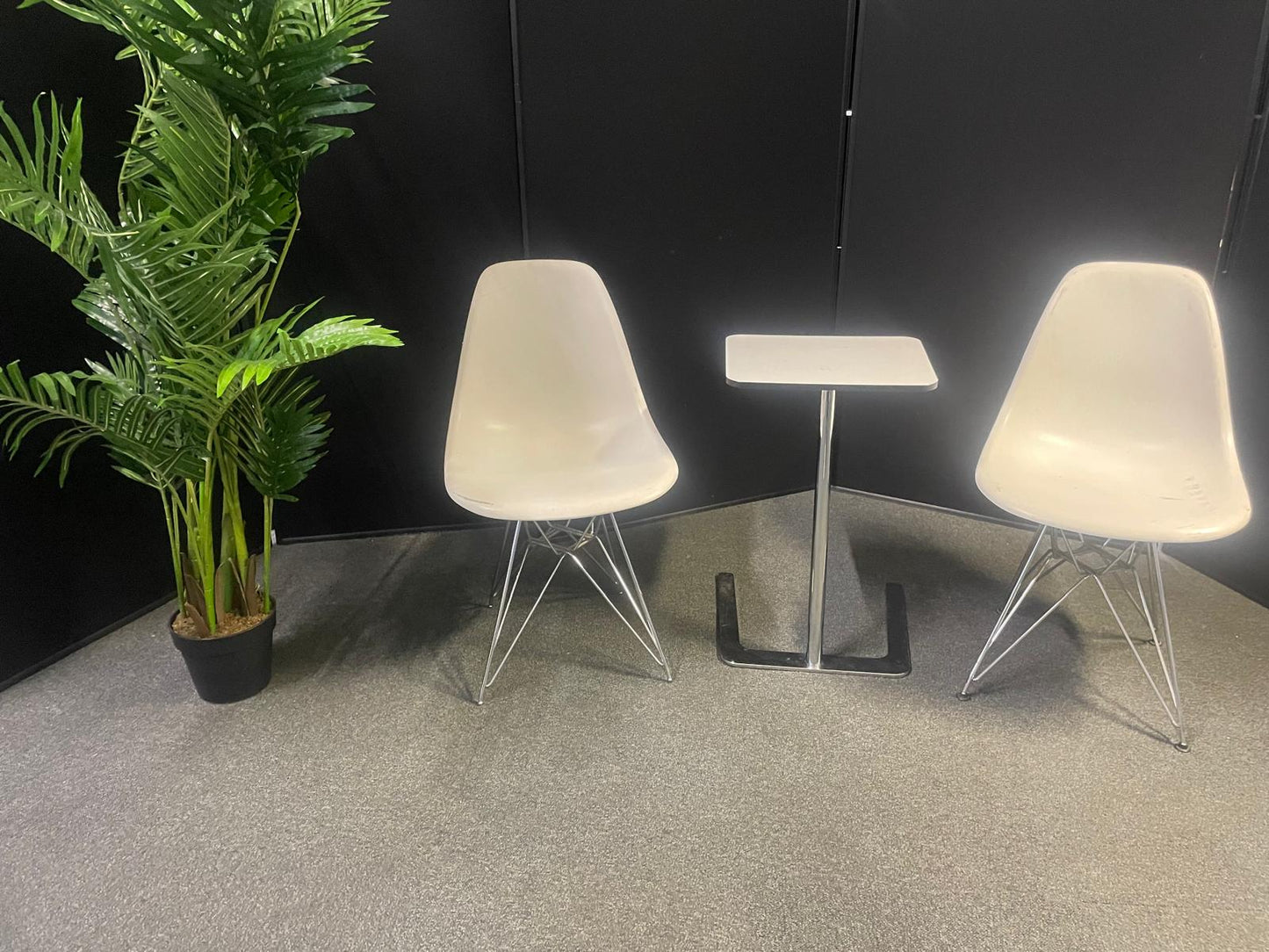 Used Eames Plastic Side Chair DSR by Vitra features a white polypropylene shell and a distinctive chrome "Eiffel" wire base