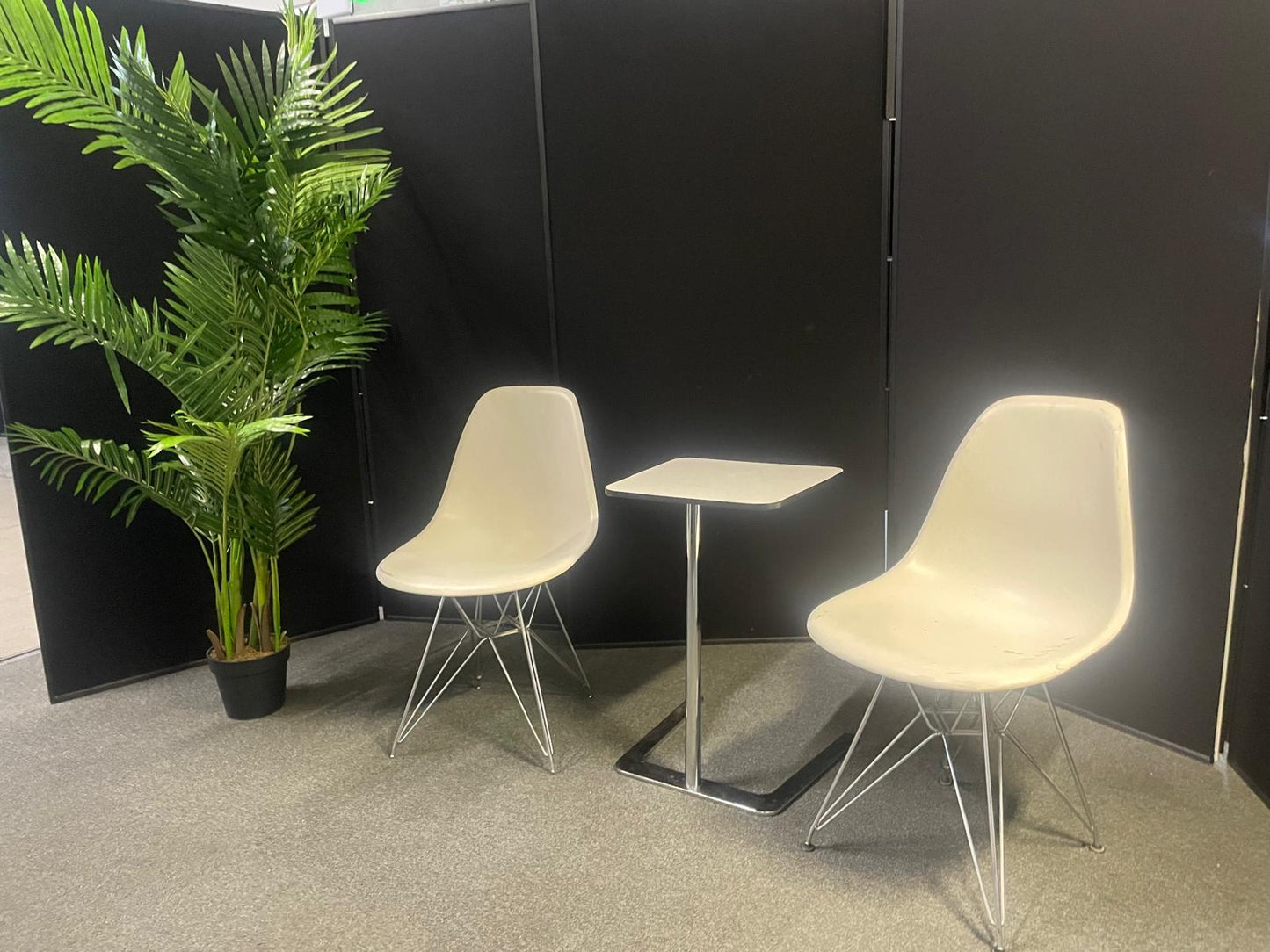 Used Eames Plastic Side Chair DSR by Vitra features a white polypropylene shell and a distinctive chrome "Eiffel" wire base