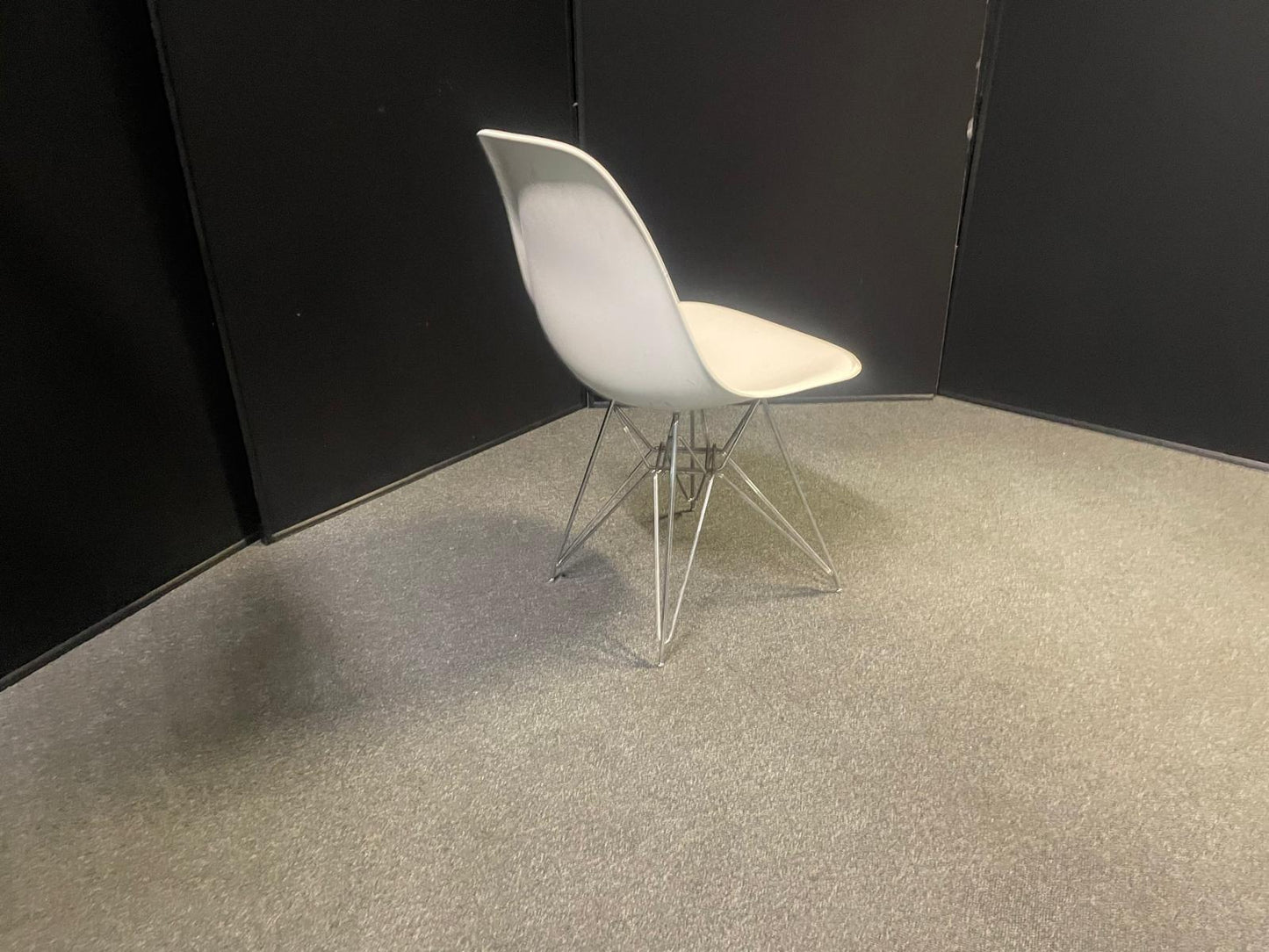 Used Eames Plastic Side Chair DSR by Vitra features a white polypropylene shell and a distinctive chrome "Eiffel" wire base