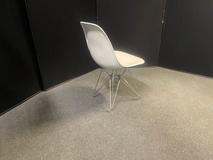 Used Eames Plastic Side Chair DSR by Vitra features a white polypropylene shell and a distinctive chrome "Eiffel" wire base