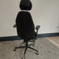 Back of black office desk chair with headrest