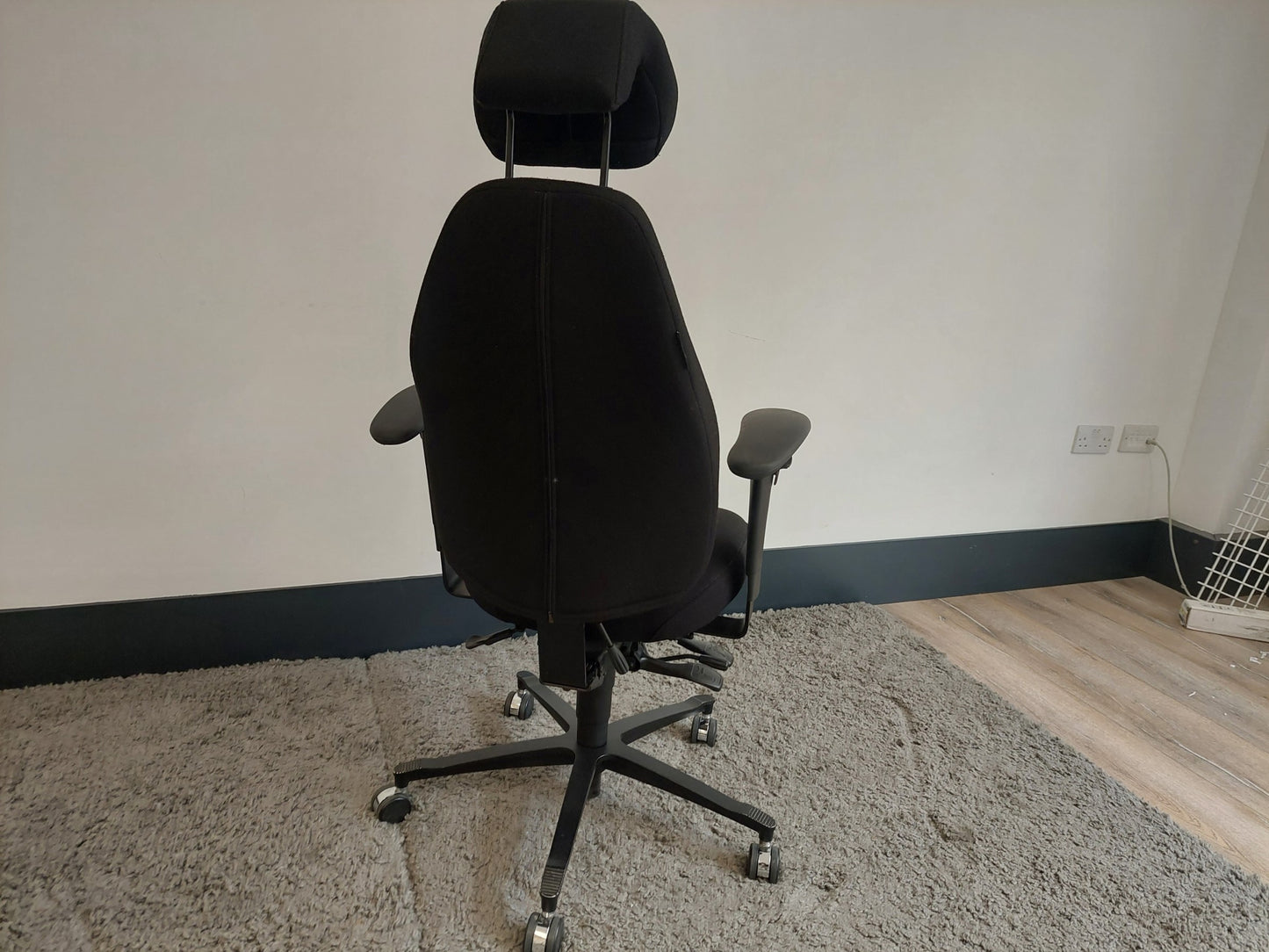 Back of black office desk chair with headrest