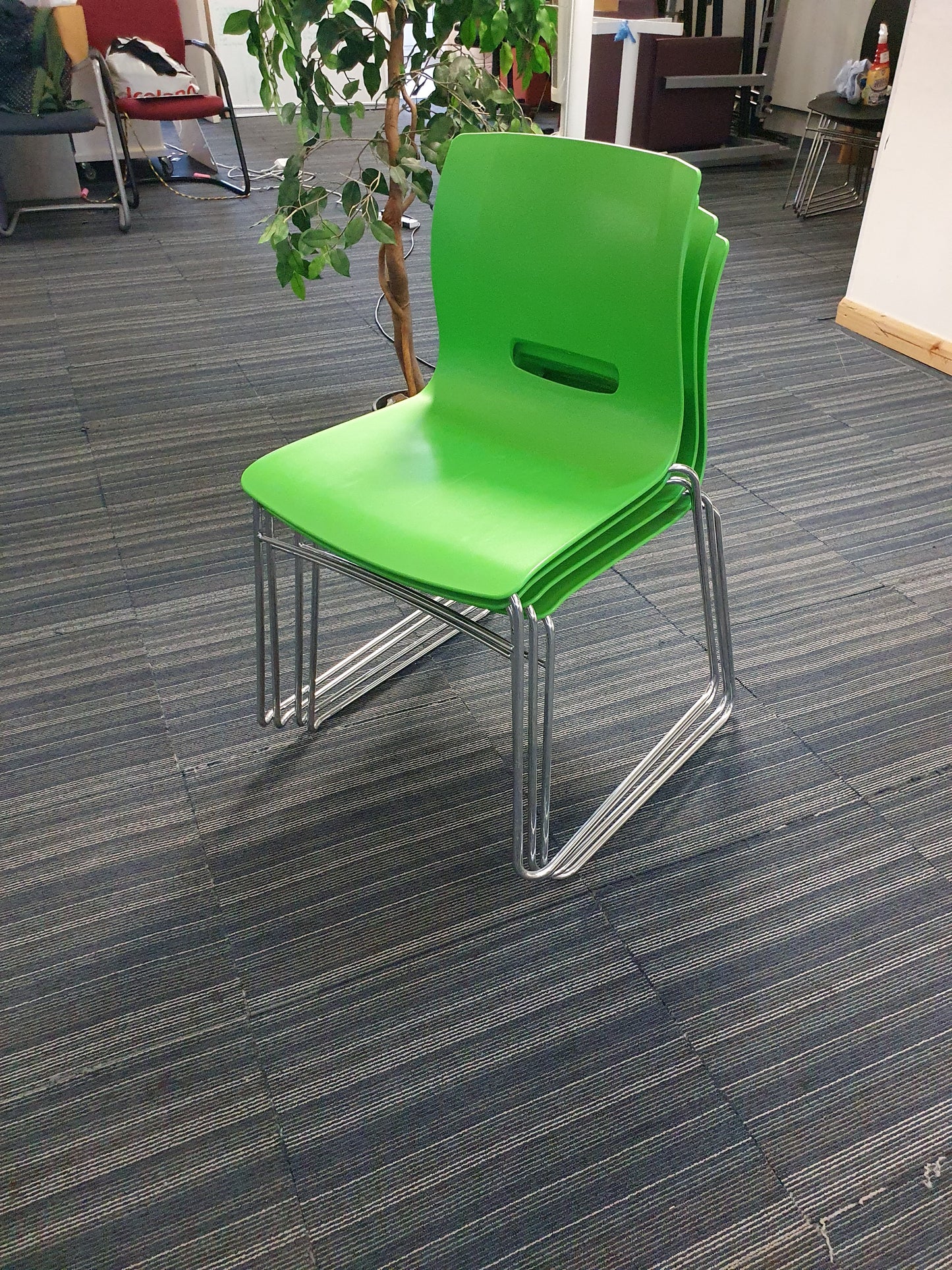 Green cantilever dining chairs stacked