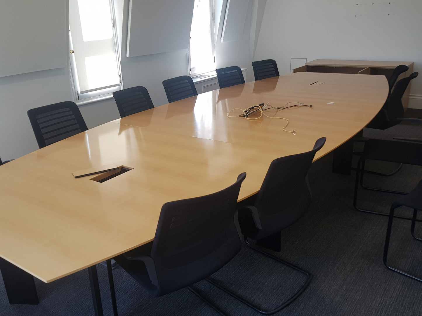       large-office-conference-table-black-chairs-windows
