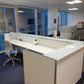 behind a white office reception desk with counter in office with chair