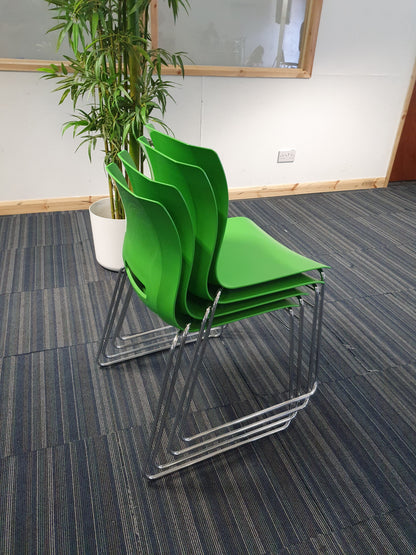 Back of green cantilever chairs stacked by Senator