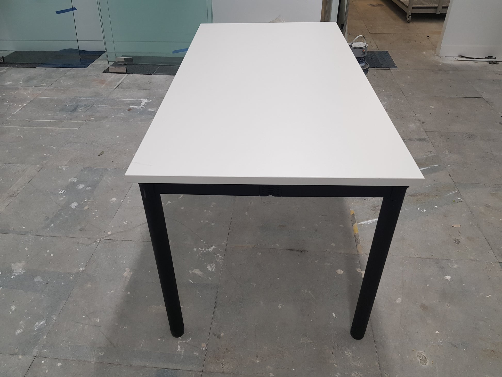 side profile of white folding office table with black legs