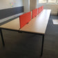 Eight seater bench desk and whiteboard in offiec