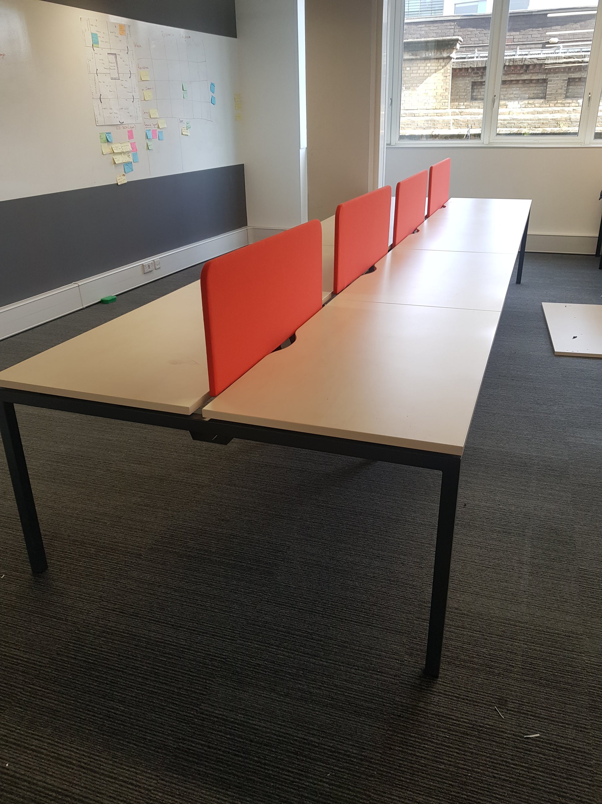 Eight seater bench desk and whiteboard in offiec