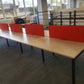 Eight pod table with four red dividers in an office