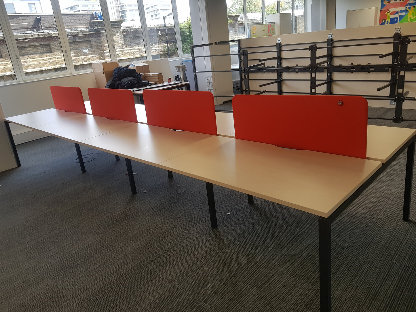 Eight pod table with four red dividers in an office