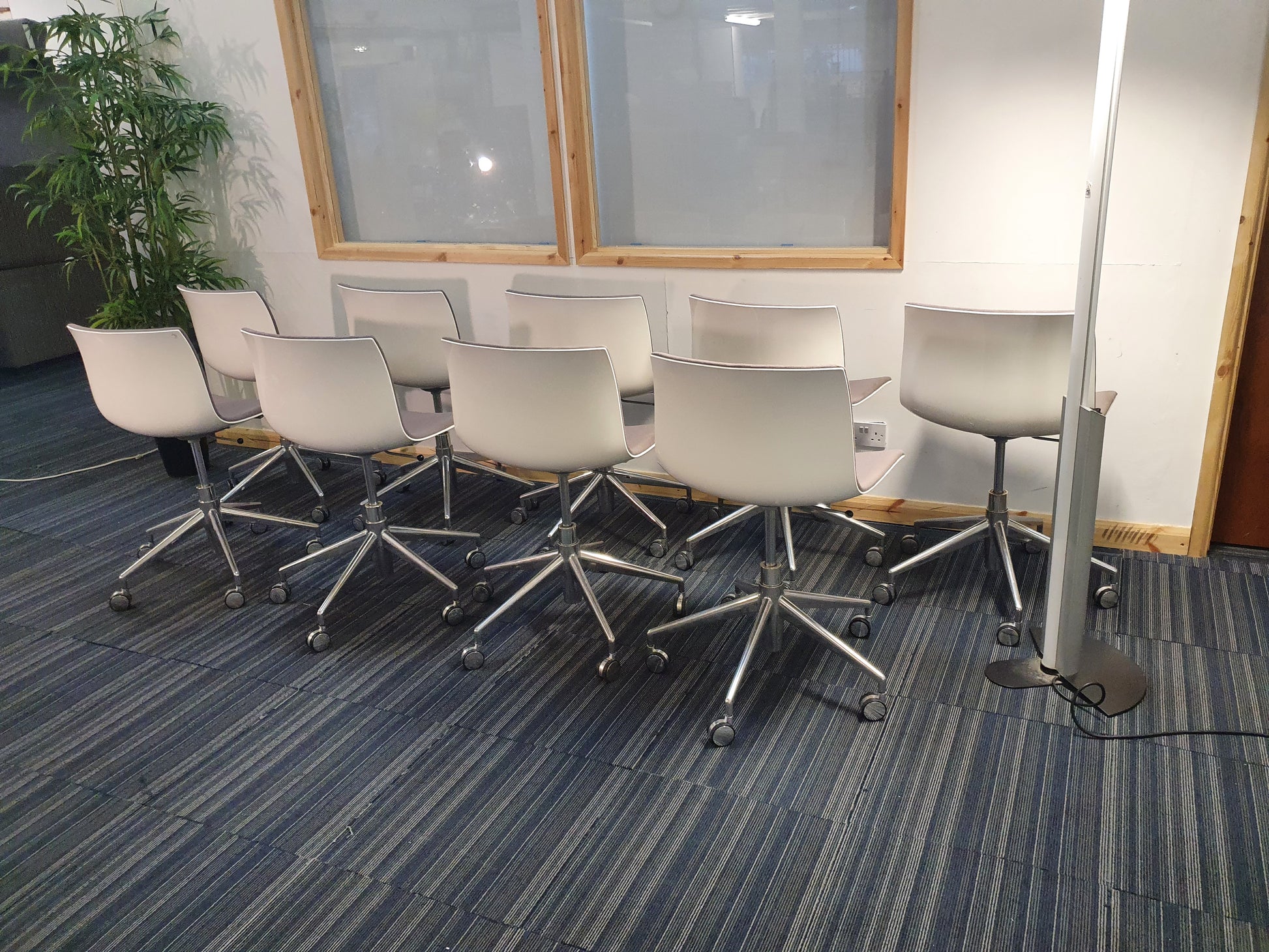 Left, tall green plant, centre, white back of  Arper Catifa Swivel Chairs