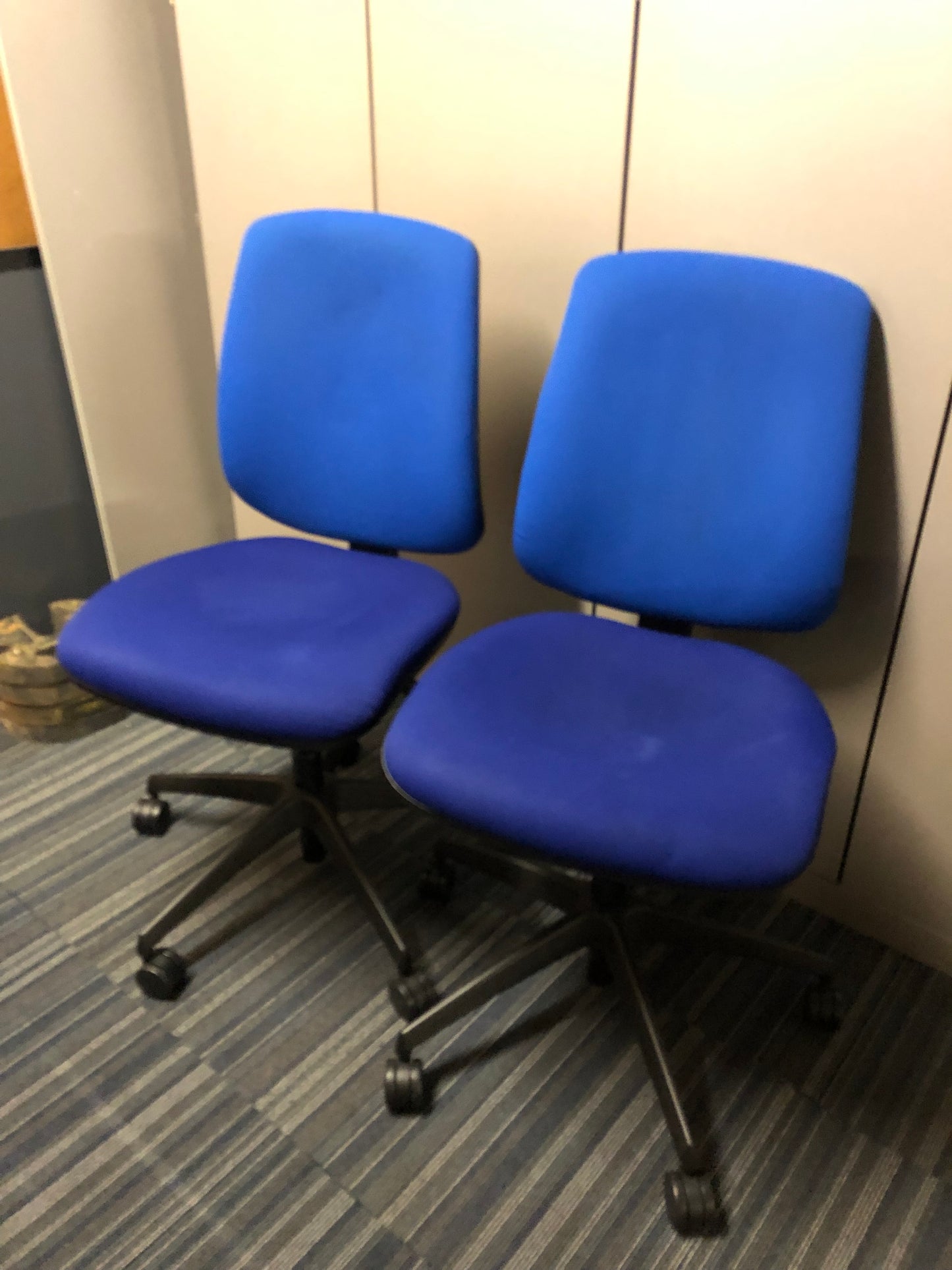 Blue Swivel chairs on castors, grey panels behind