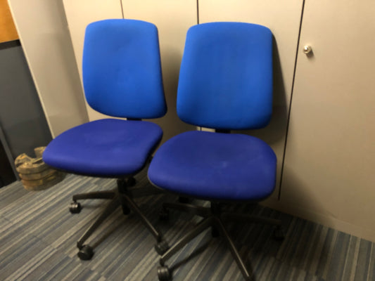 Two Blue fabric office chairs on wheels in front of grey cupboard