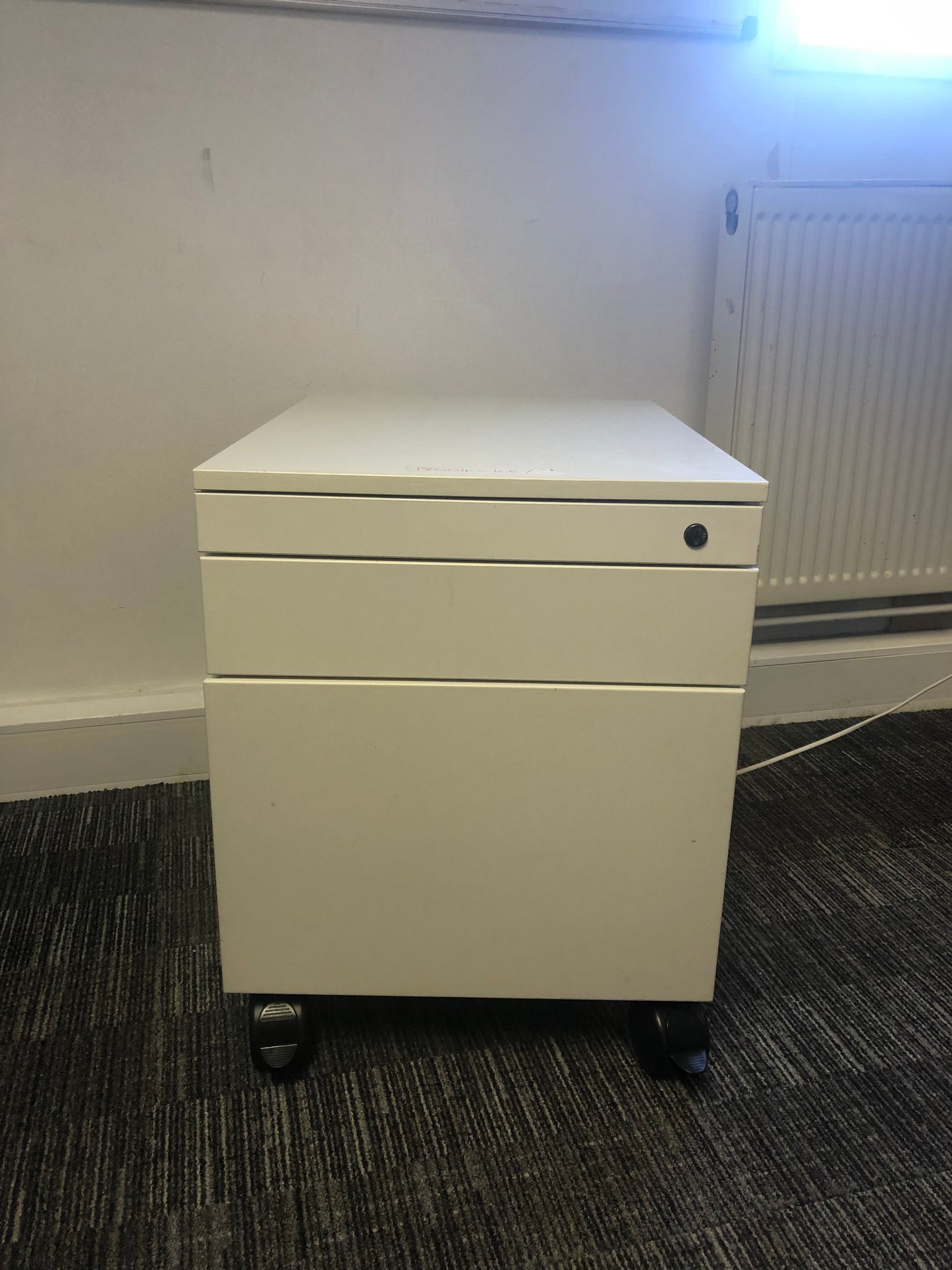 White mobile office drawer on carpet